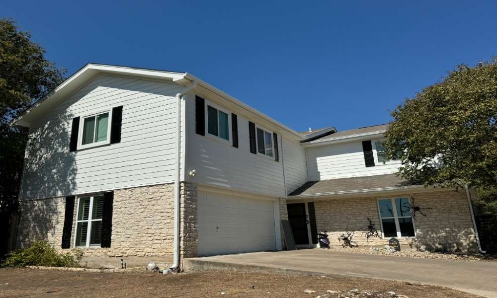 White Hardie siding on a two-story home with stone base in Austin, TX