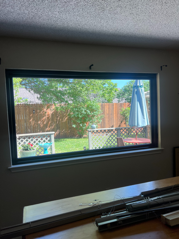Black-framed picture window looking onto a backyard in Austin, TX