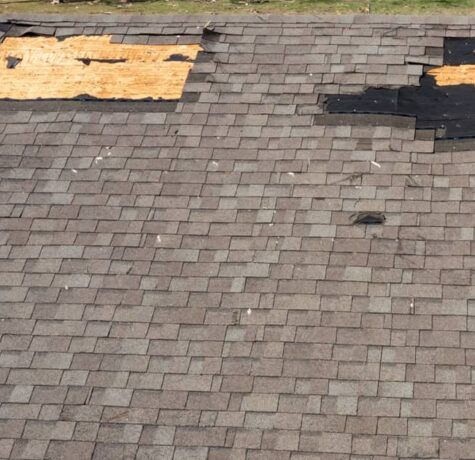 How to tell if you need a new roof showing curling shingles and visible roof damage