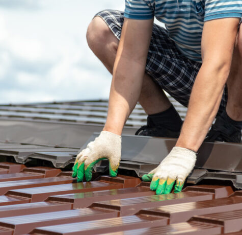Technician performing inspection for a metal roof maintenance guide to extend roof lifespan