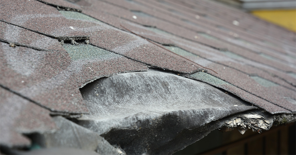 asphalt shingles roof with visible warning signs including curling and damaged shingles
