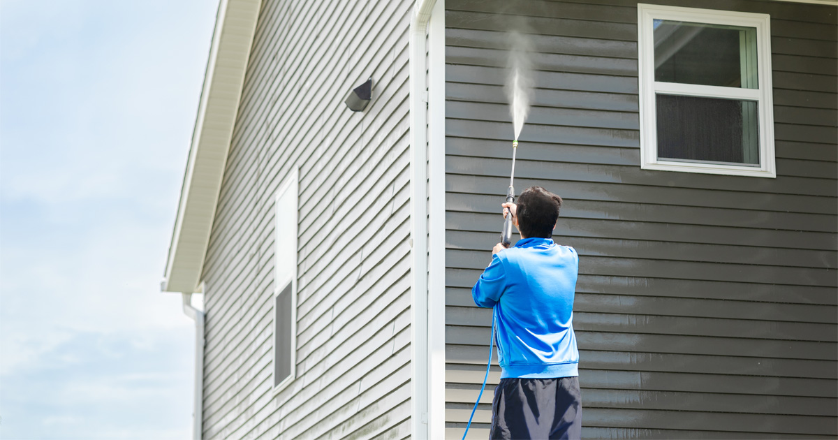Homeowner showing how to maintain siding with exterior cleaning and inspection tips