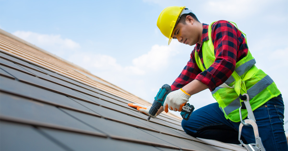 Homeowner protecting your roof from weather damage through seasonal roofing inspection and maintenance