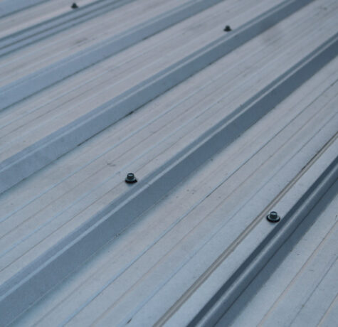Metal Roof Lifespan illustrated by a modern residential metal roof in excellent condition