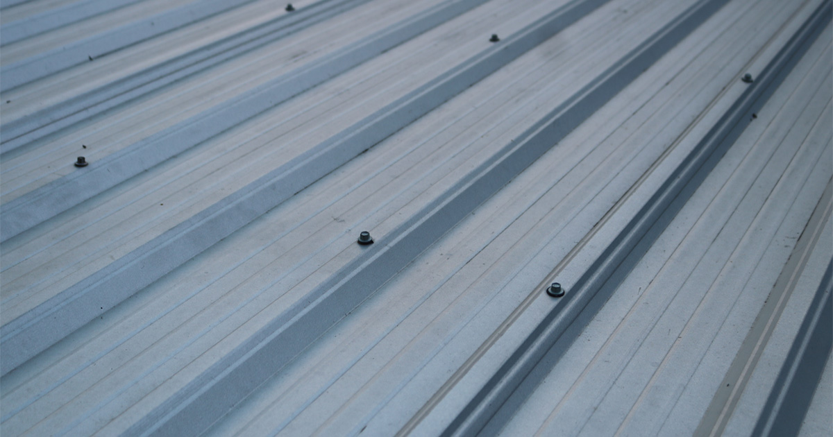 Metal Roof Lifespan illustrated by a modern residential metal roof in excellent condition