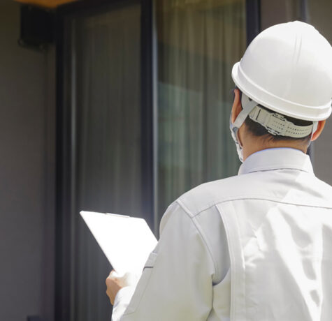 Homeowner reviewing a siding estimate with a contractor outside her Austin, TX home